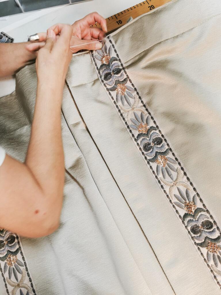 Sewing decorative trim on curtain